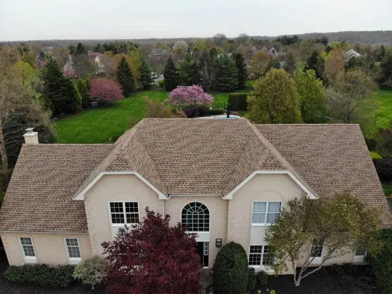 Finished architectural shingle roof on a two-story home