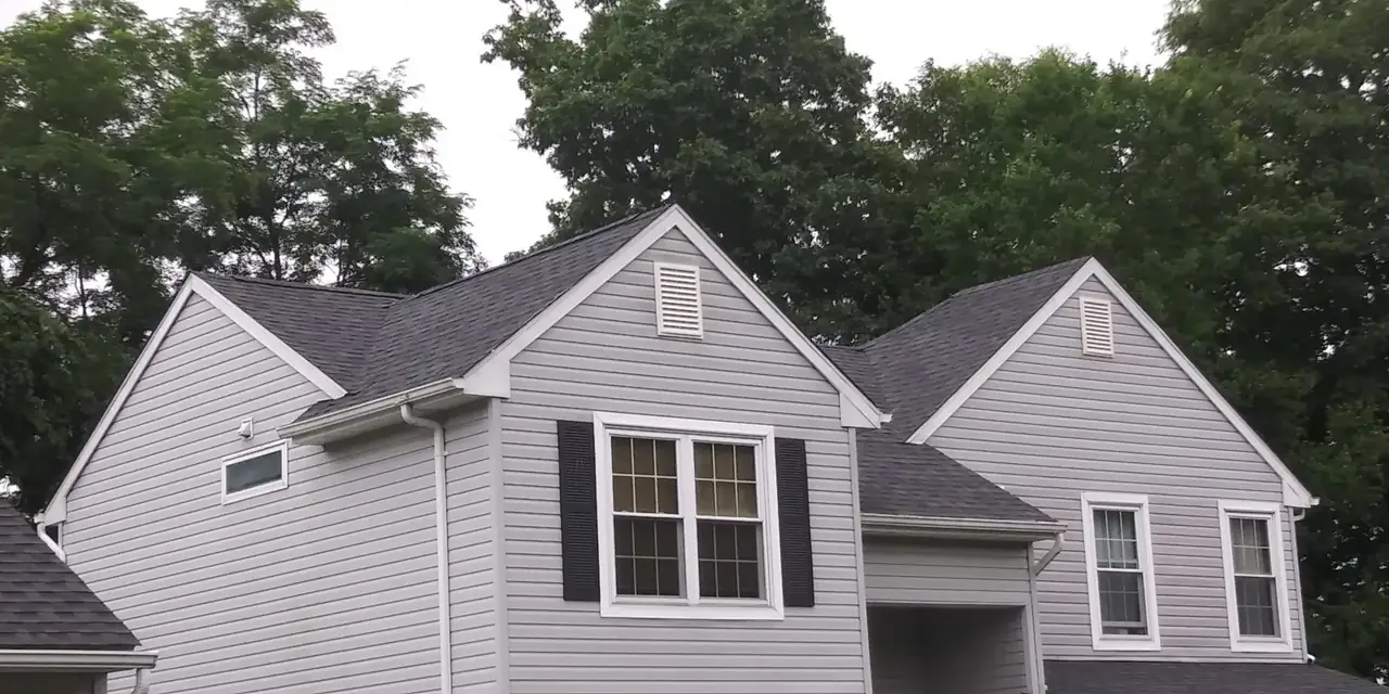 Side elevation of a home with a newly installed shingle roof