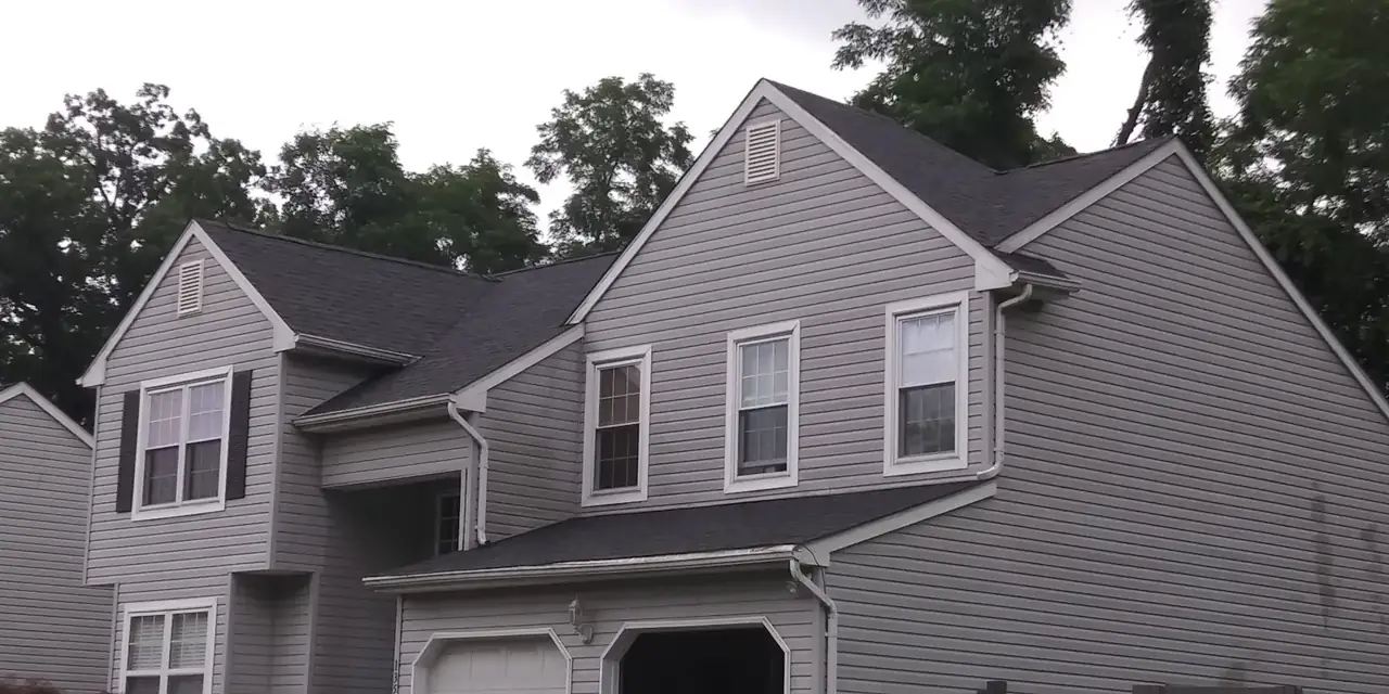 Right side of a two-story home with a new shingle roof