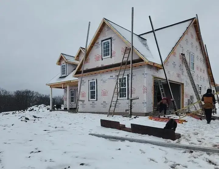 Winter new-construction job with framing and house wrap