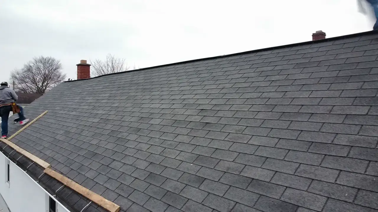 Close-up of a newly shingled roof plane with drip edge
