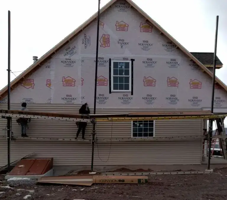 New construction wrapped in house wrap ready for siding
