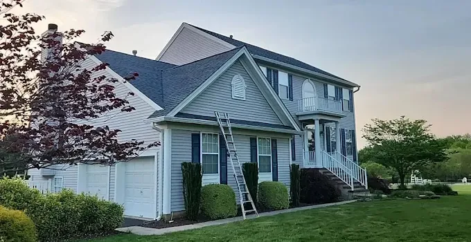 Ladder set against a home during gutter and roofline work