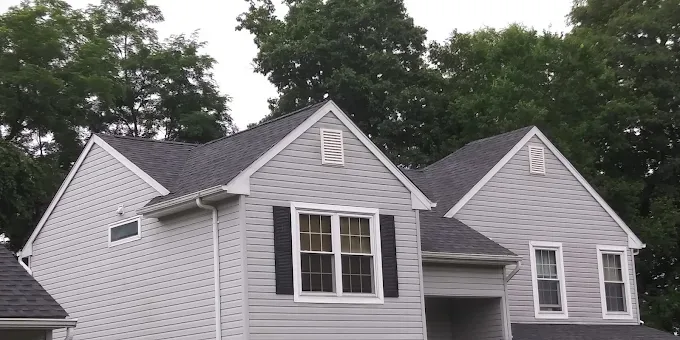 Gutter and downspout along the edge of a residential roof