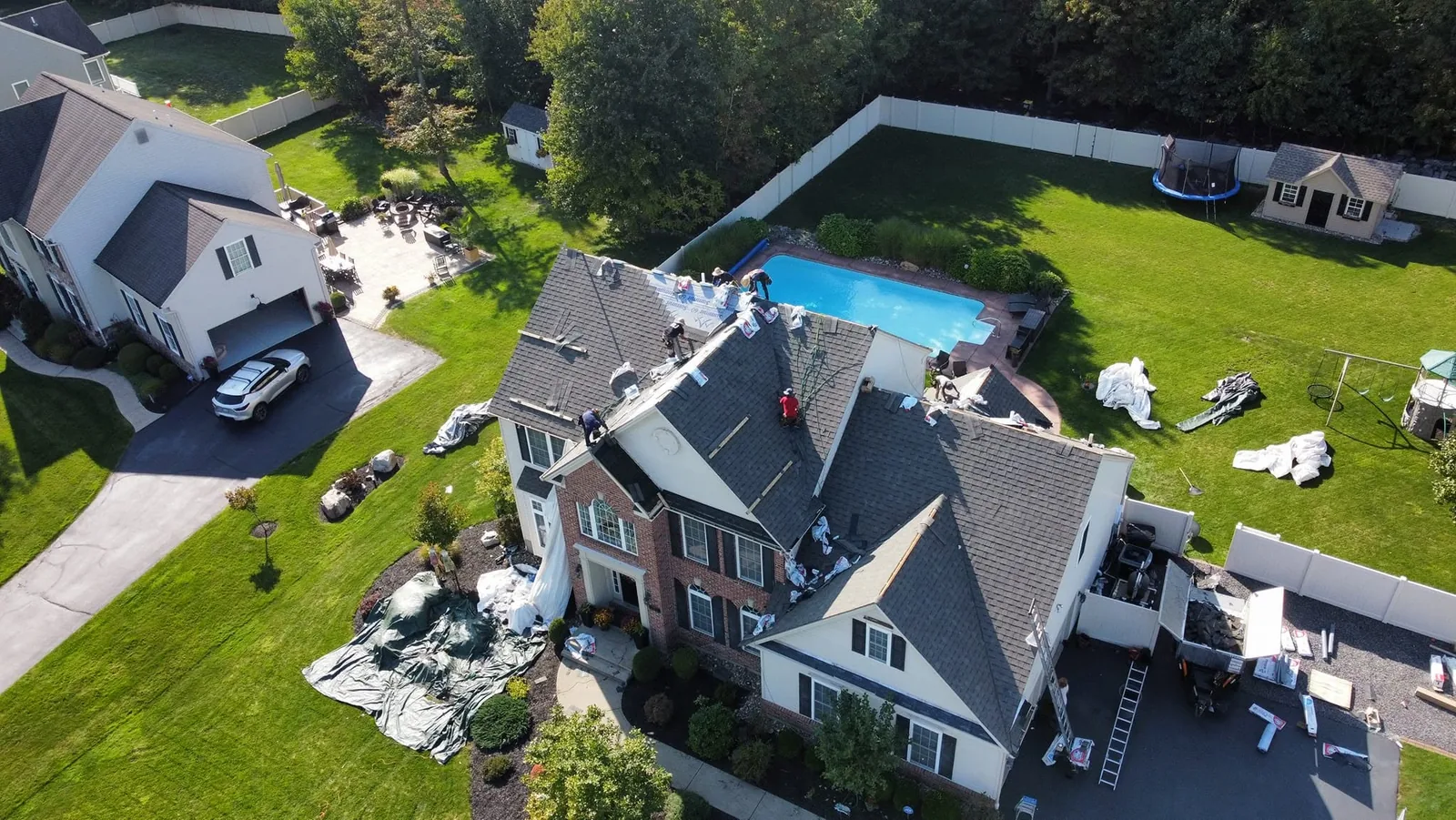 Aerial view of a completed roof replacement on a large residential property