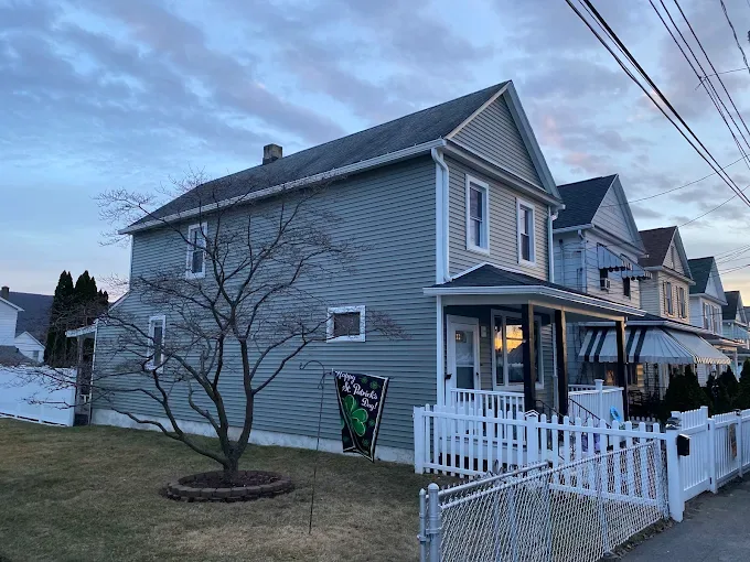 Blue lap siding on a two-storey home with white trim and porch