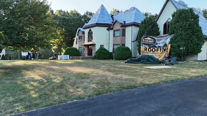 Storm-damaged roof covered and staged for repair by Allabaugh Construction