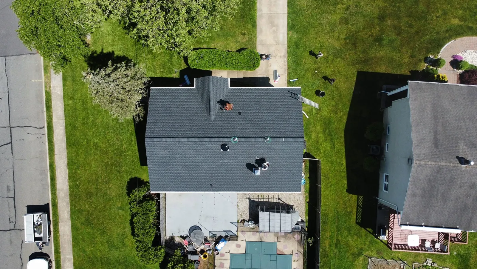 Aerial view of a storm-damaged roof being stripped and rebuilt