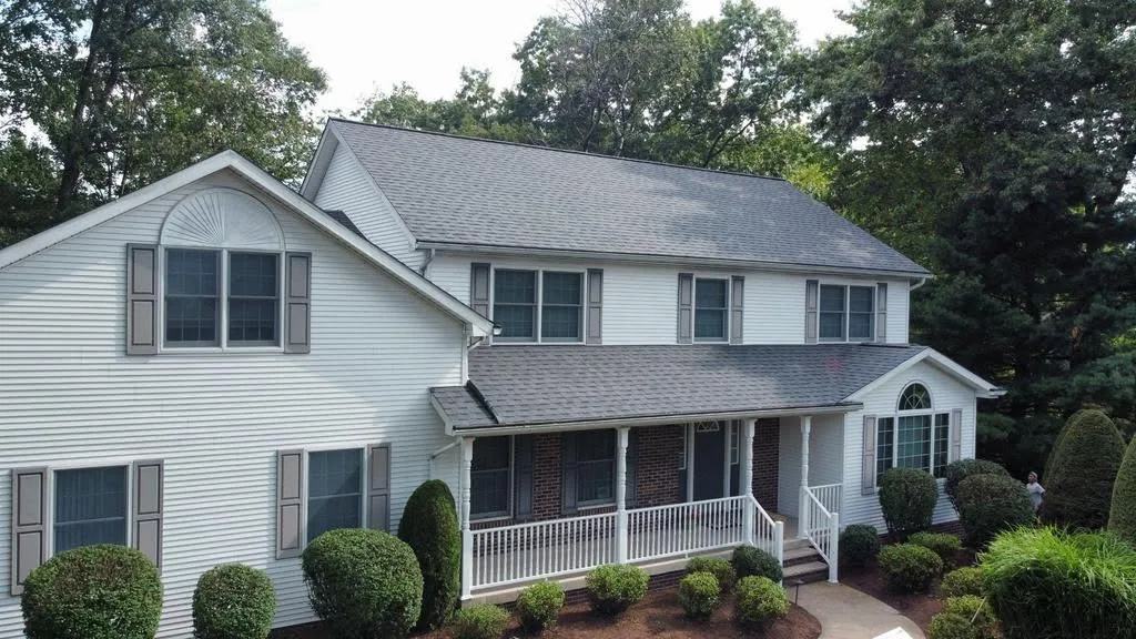 Two-storey home with a completed replacement roof after storm damage