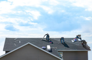 roofers on asphalt roof