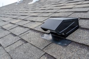 residential roof with asphalt shingles and exhaust vent