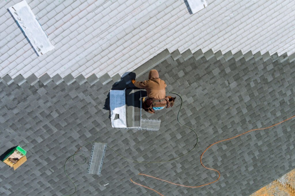 Professional roofer installing a new roofing system on a home
